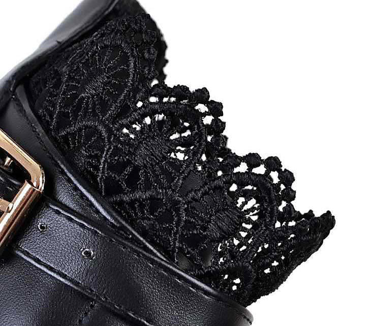 Close-up of intricate black lace detail on stylish gothic women's boot, showcasing elegance and design.