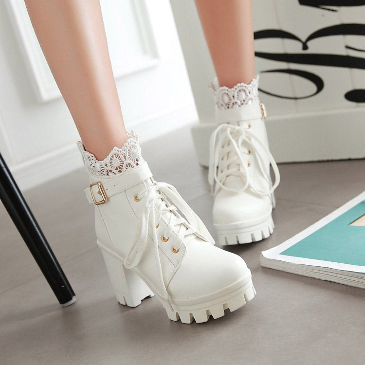 White lace-up gothic ankle boots with heels, featuring decorative lacy cuffs and stylish metal buckles.
