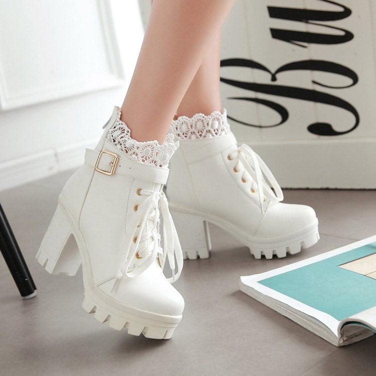Stylish white gothic ankle boots with lace details and metal buckles, perfect for winter fashion.