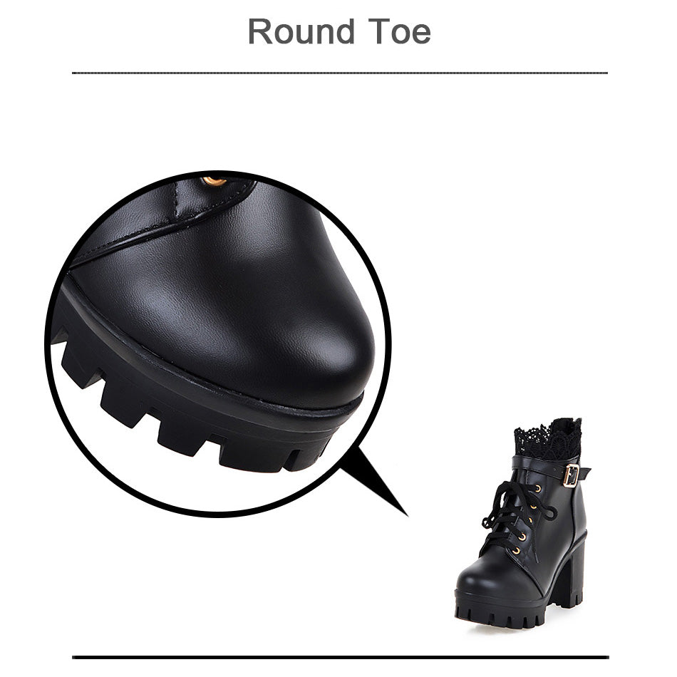 Close-up of round toe black PU leather gothic ankle boots with lace-up design and chunky platform.