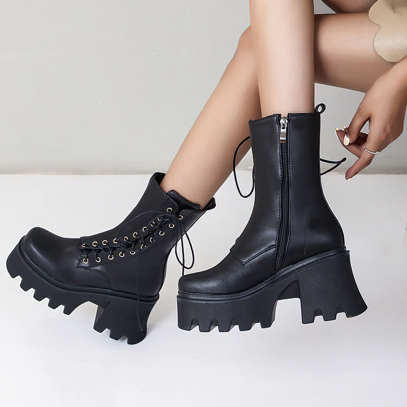 Gothic stylish women's black PU leather ankle boots with lace-up design and chunky tractor soles.