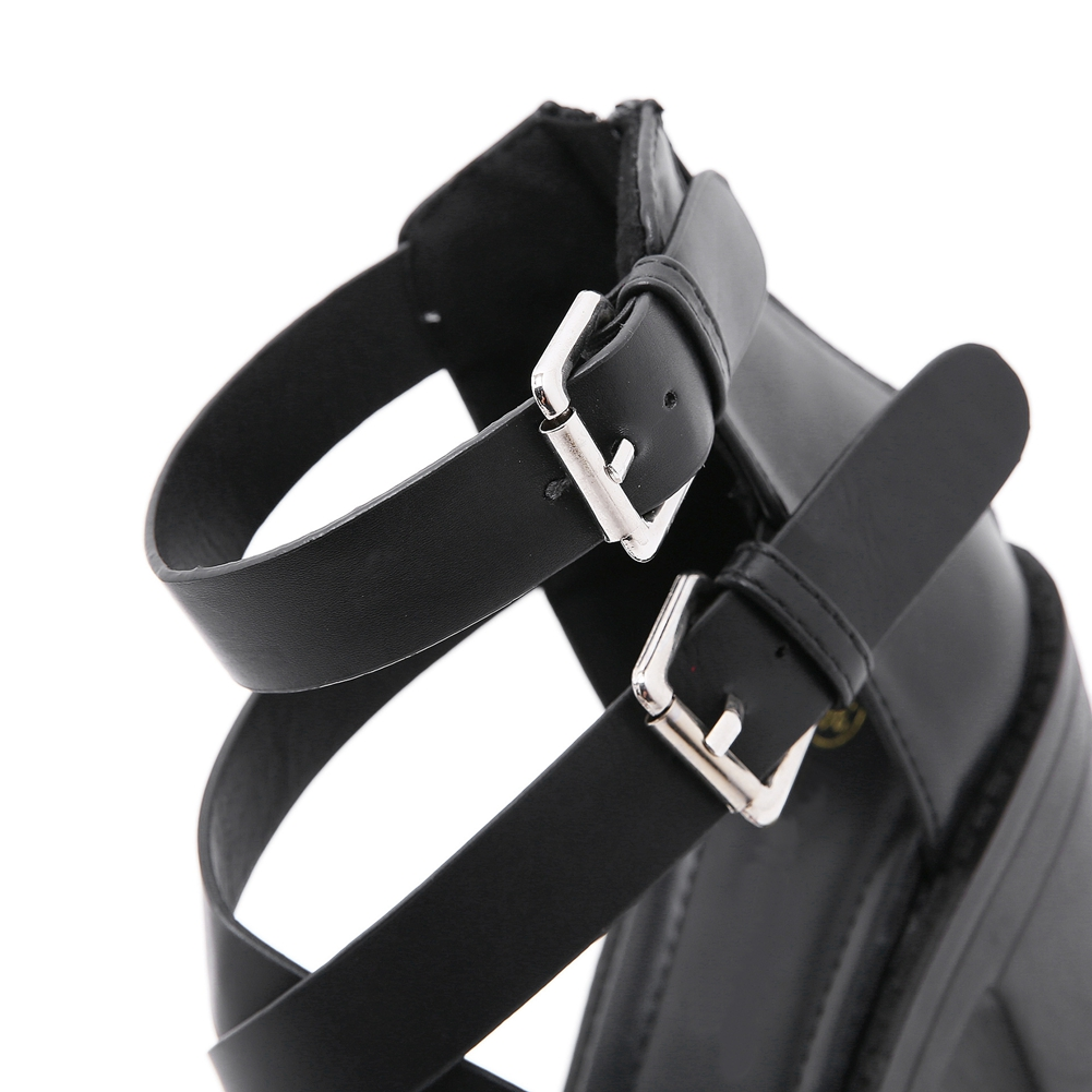 Close-up view of stylish black PU leather high heel sandals with fashionable buckles for women's gothic look.