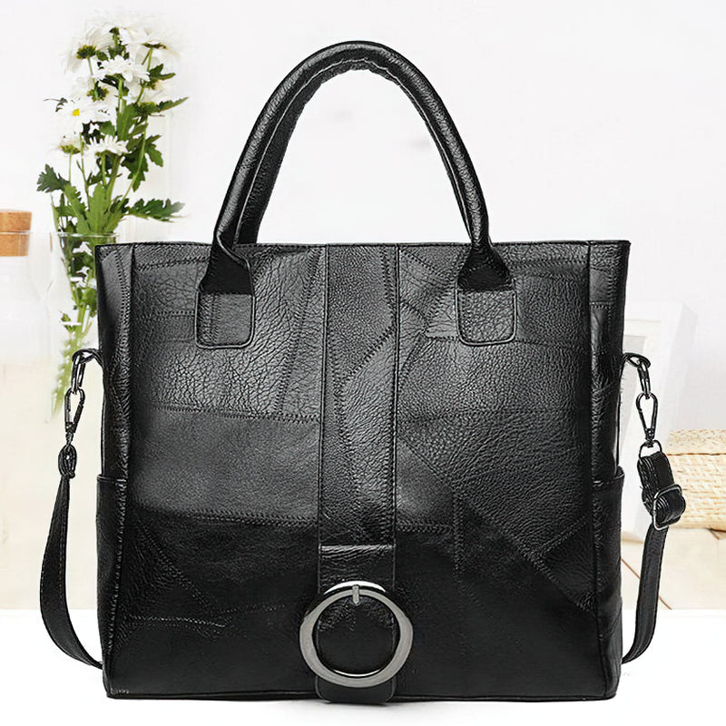 Minimalistic black pu leather handbag with stylish ring decoration, ideal for travel and everyday use.