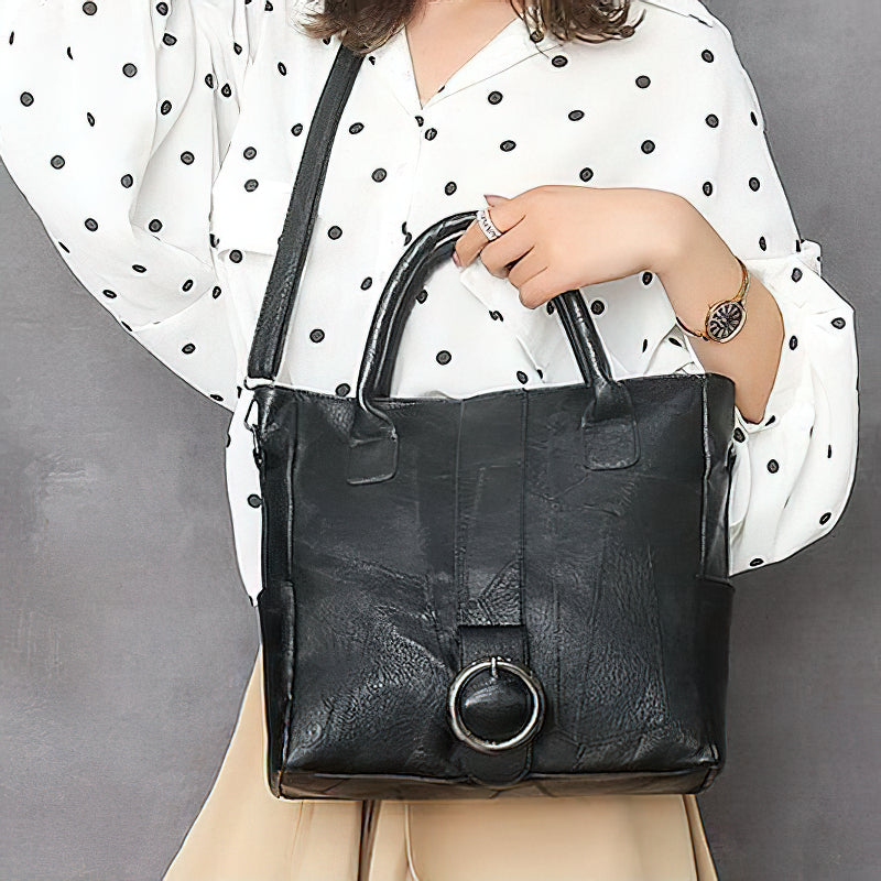 Stylish black pu leather women's retro handbag with ring decoration, perfect for travel or everyday use.