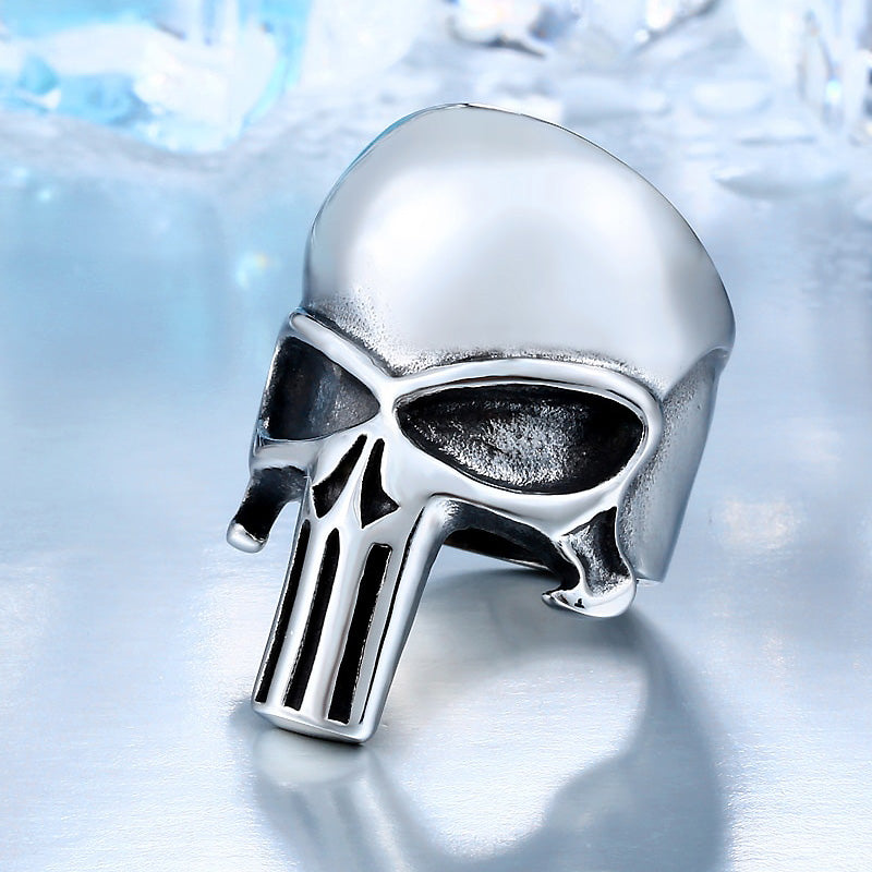 Stainless steel Punisher skull ring on a polished surface, perfect for rock style fashion accessories.