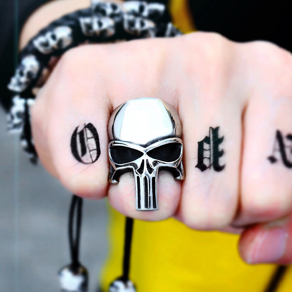 Stainless steel Punisher skull ring worn on hand, showcasing rock style fashion jewelry and intricate tattoo designs.