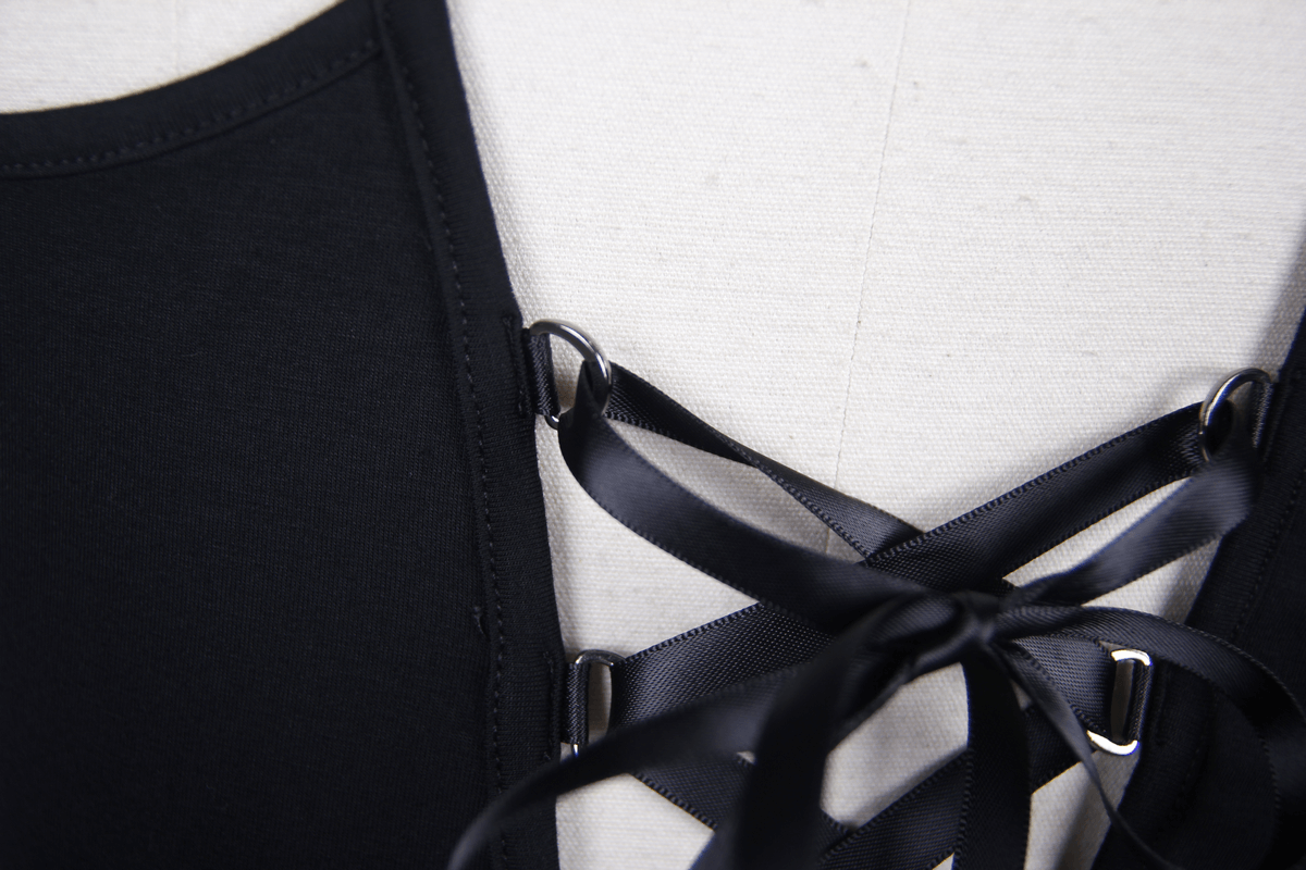 Close-up of black gothic t-shirt featuring stylish mesh inserts and satin ribbon lacing detail.