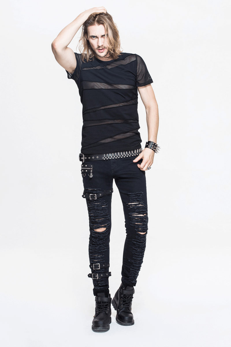 Stylish man in a punk black short sleeve t-shirt with mesh, paired with edgy ripped jeans and accessories.