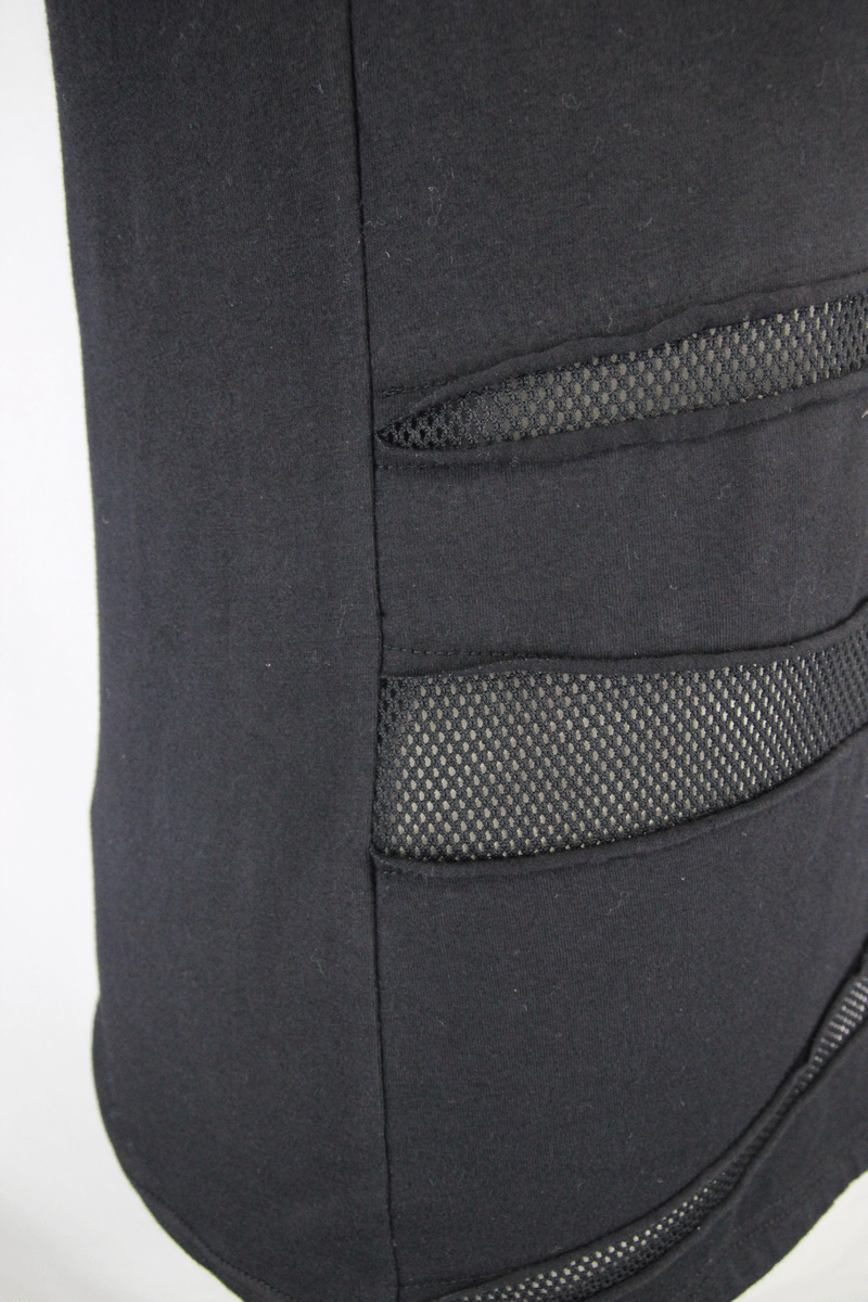 Close-up of black men's asymmetrical t-shirt featuring mesh panels for a punk-inspired look.