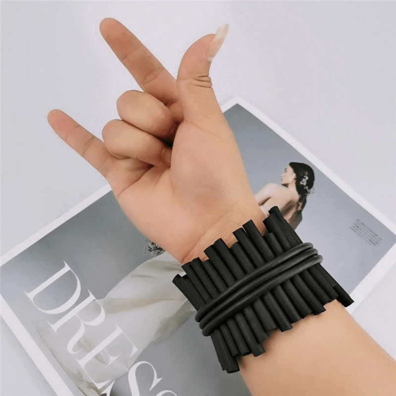 Handmade punk black rubber wide bracelet featured on a hand making a rock sign, showcasing modern silicone style.