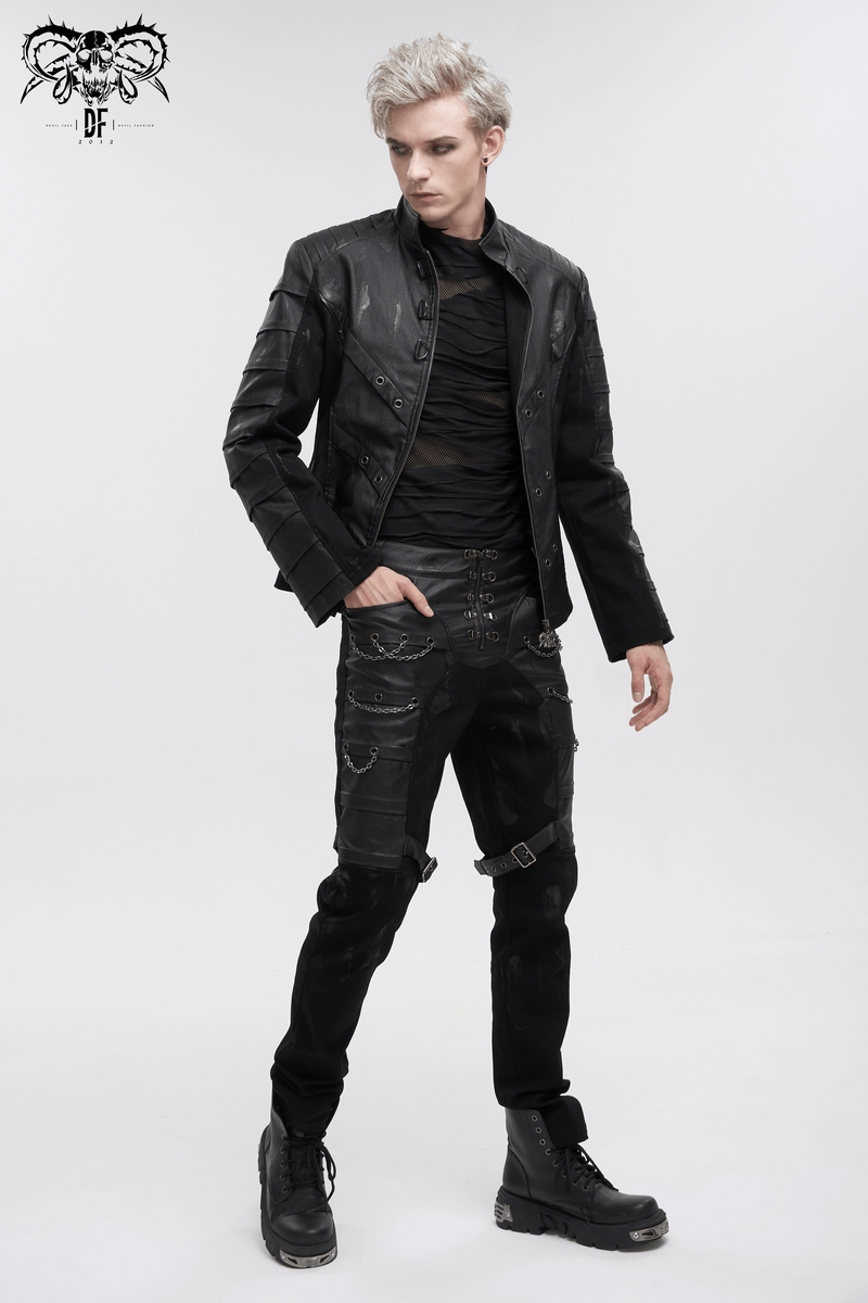 Stylish male model in black fitted punk pants with buckles and a black jacket, showcasing gothic fashion.