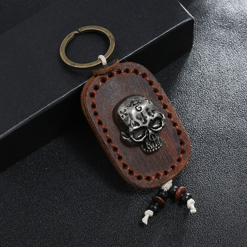 Punk genuine leather keychain with silver skull pendant, stylish accessory for men and women, perfect for bags.