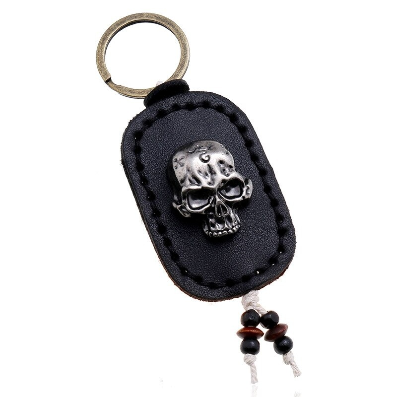 Punk genuine leather keychain featuring a silver skull pendant, perfect accessory for bags and keys.
