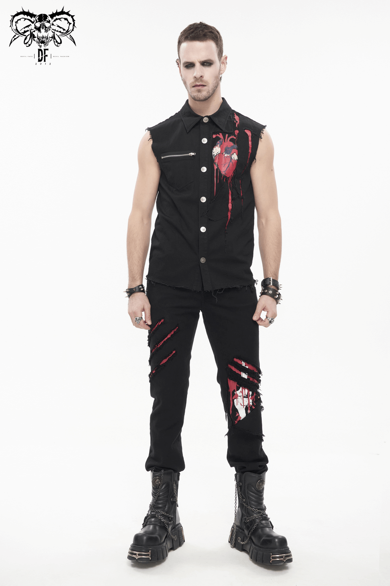 Trendy men's punk sleeveless black shirt with heart print and ripped details, styled with black pants and chunky boots.