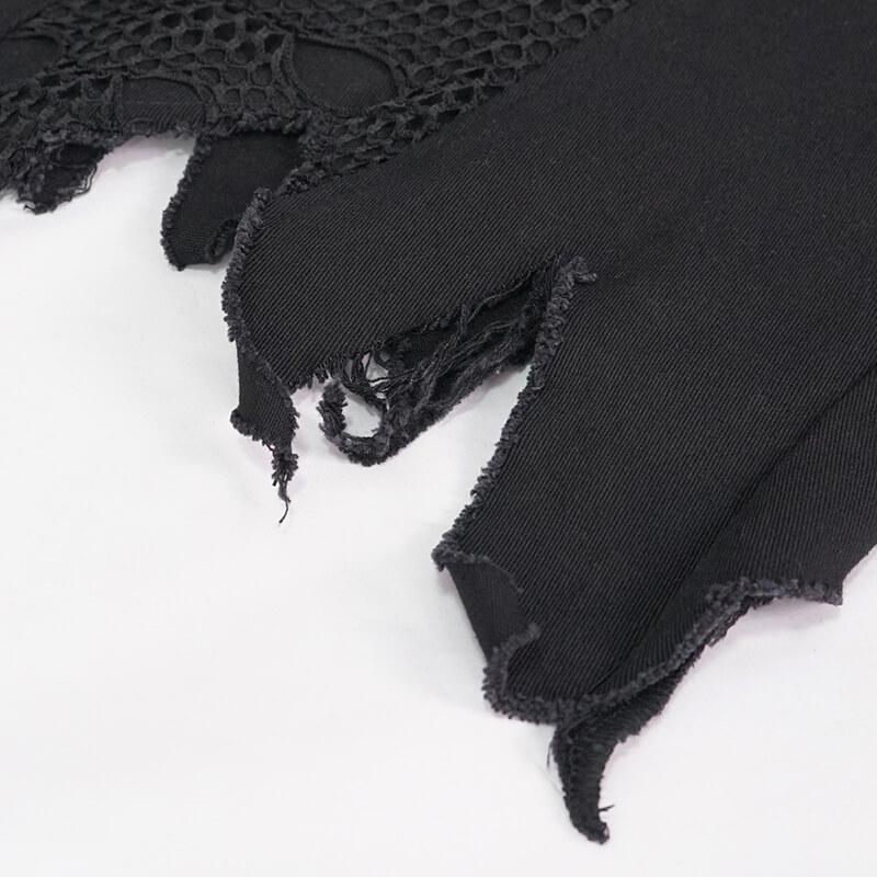 Close-up of black punk vest fabric showing unique textures and edgy design details.