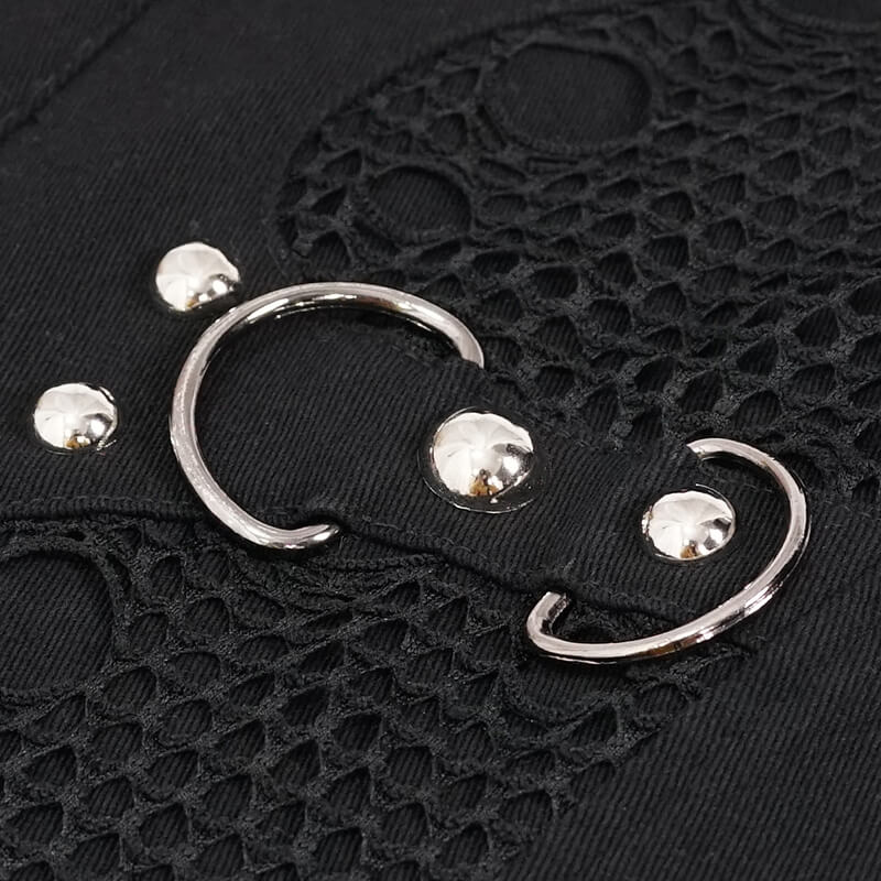Close-up of a punk black waistcoat featuring silver loops and buttons for a trendy look.