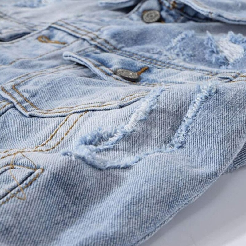 Close-up of a punk men's ripped denim vest showcasing cool patches and distressed details in blue fabric.
