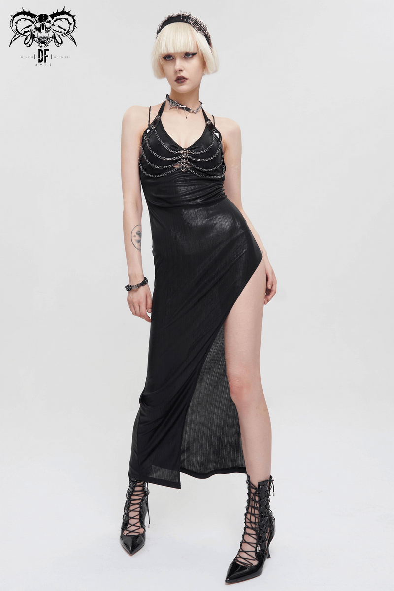 Stylish model wearing a black slinky dress with a thigh-high slit and punk accessories, showcasing edgy fashion.