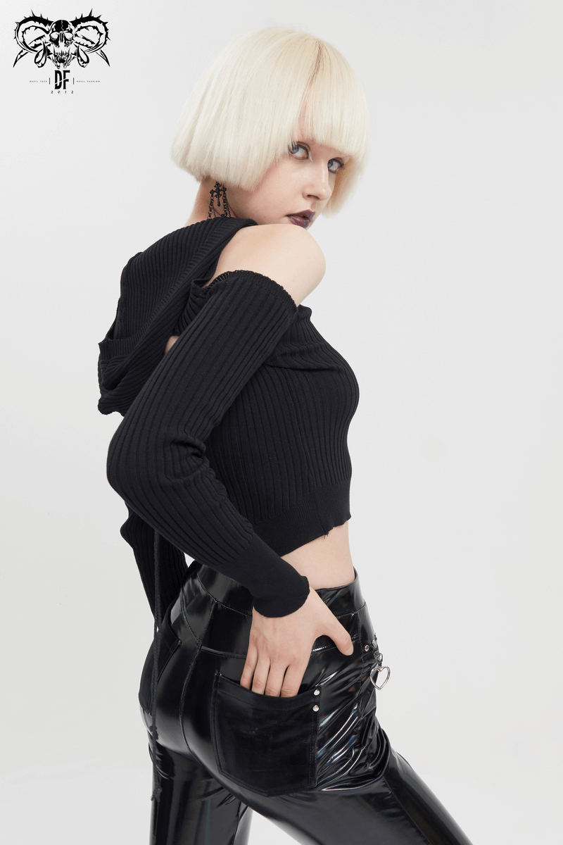 Women's black off-shoulder knitted hooded top styled with edgy black pants.