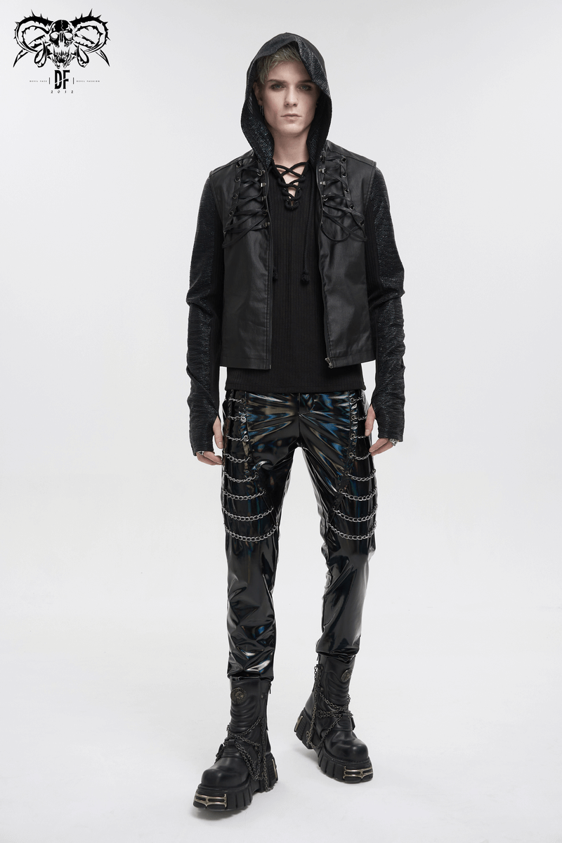 Fashionable model wearing black punk patent leather pants with chains and a stylish black hooded jacket.