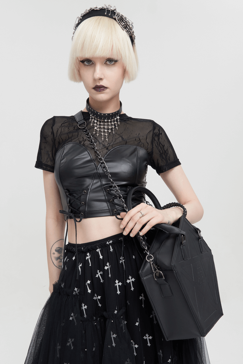 Gothic woman in black outfit holding a Punk Pentagon Crossbody Bag, featuring chain decor, perfect for stylish gothic looks.
