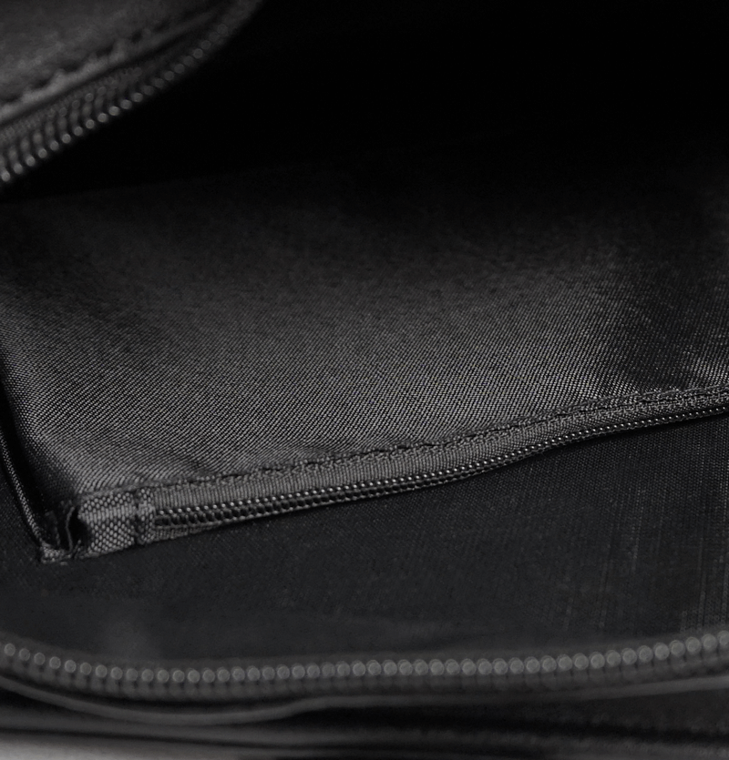 Interior view of a gothic black crossbody bag showcasing spacious compartments and sleek design.