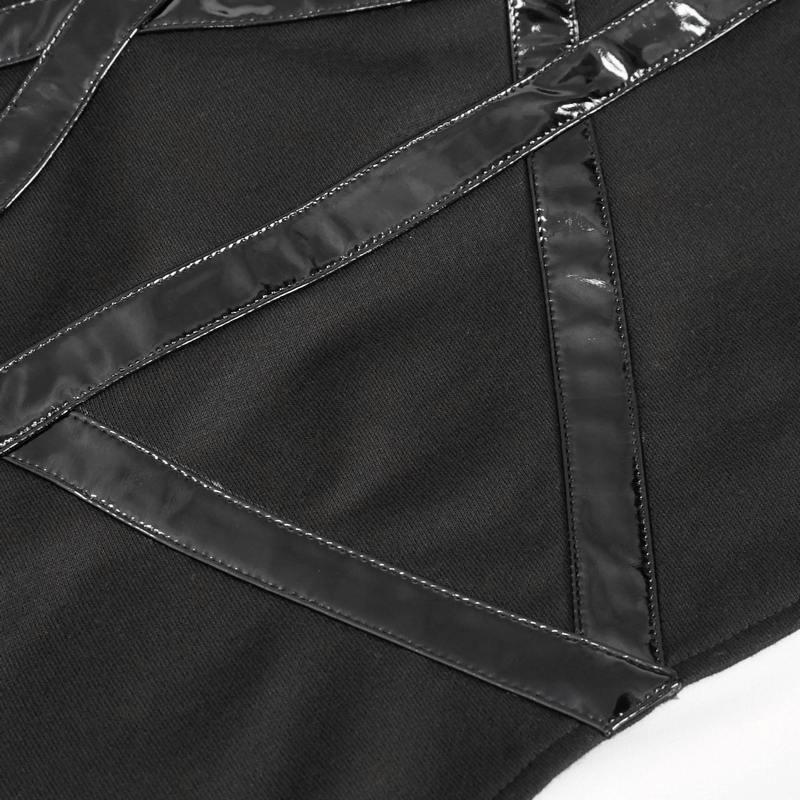 Close-up of the asymmetric black top featuring glossy strap details for a punk style vibe.