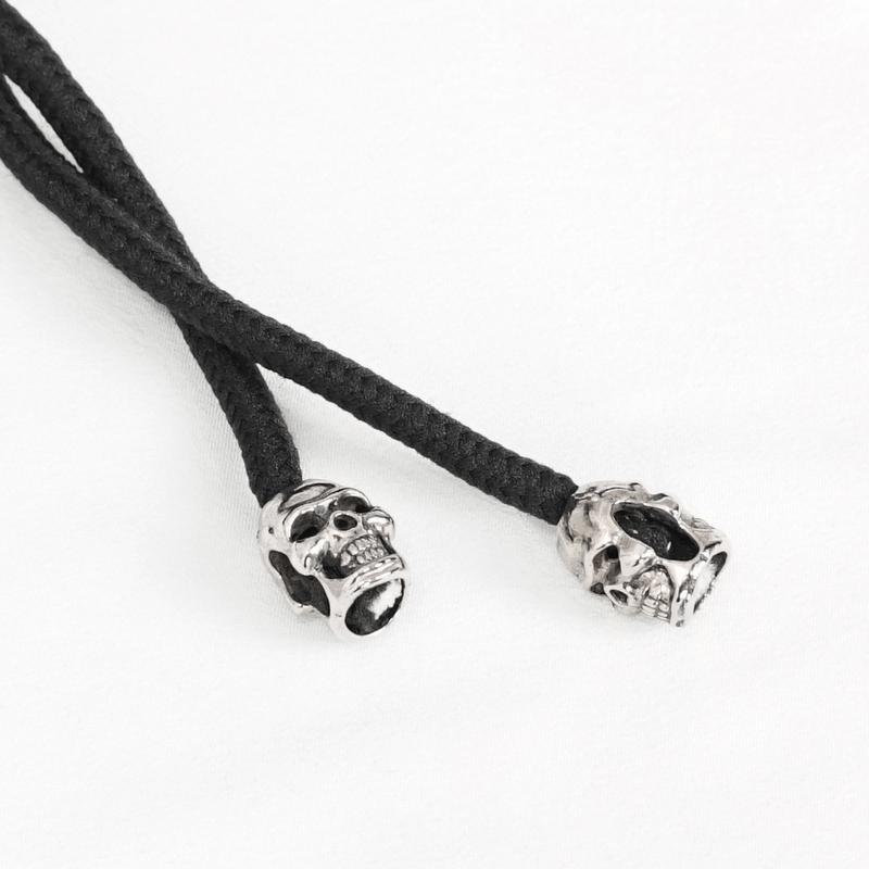 Black rope with silver skull ends, perfect for a punk or gothic accessory to enhance your style.