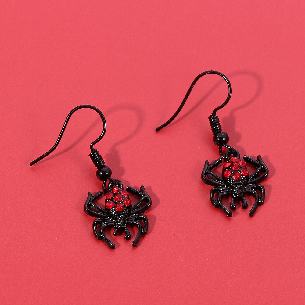 Punk red rhinestone spider earrings on a vibrant background, perfect gothic accessories for Halloween fashion.