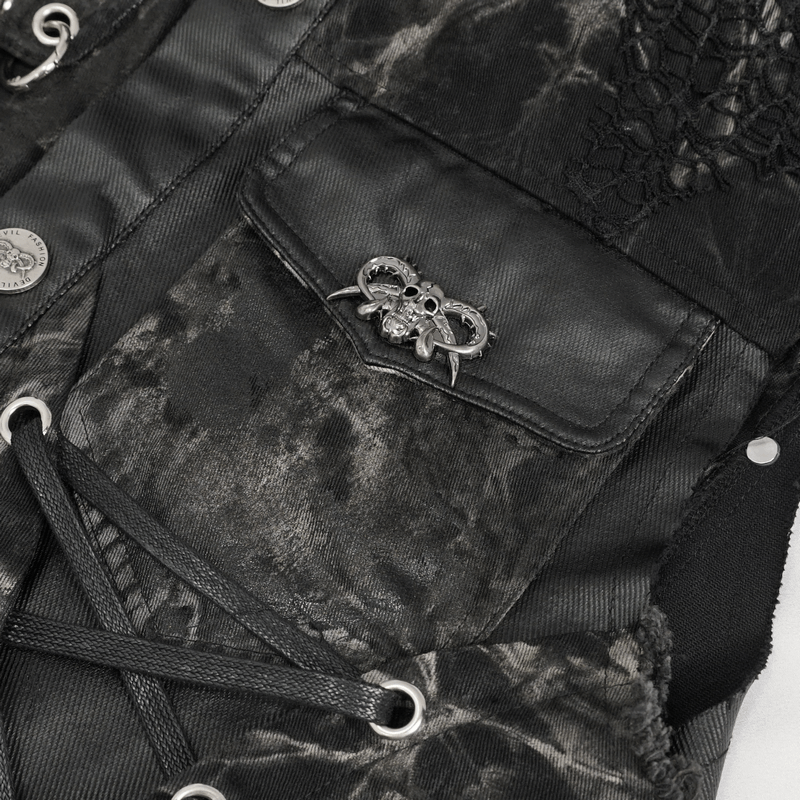 Close-up of punk rock asymmetrical waistcoat with skull rivet and pocket detail, featuring gothic mesh accents.