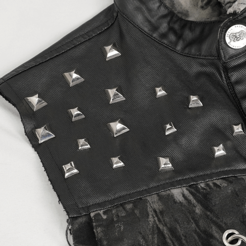 Close-up of punk rock vest with gothic rivets and asymmetrical design, showcasing unique edgy style.