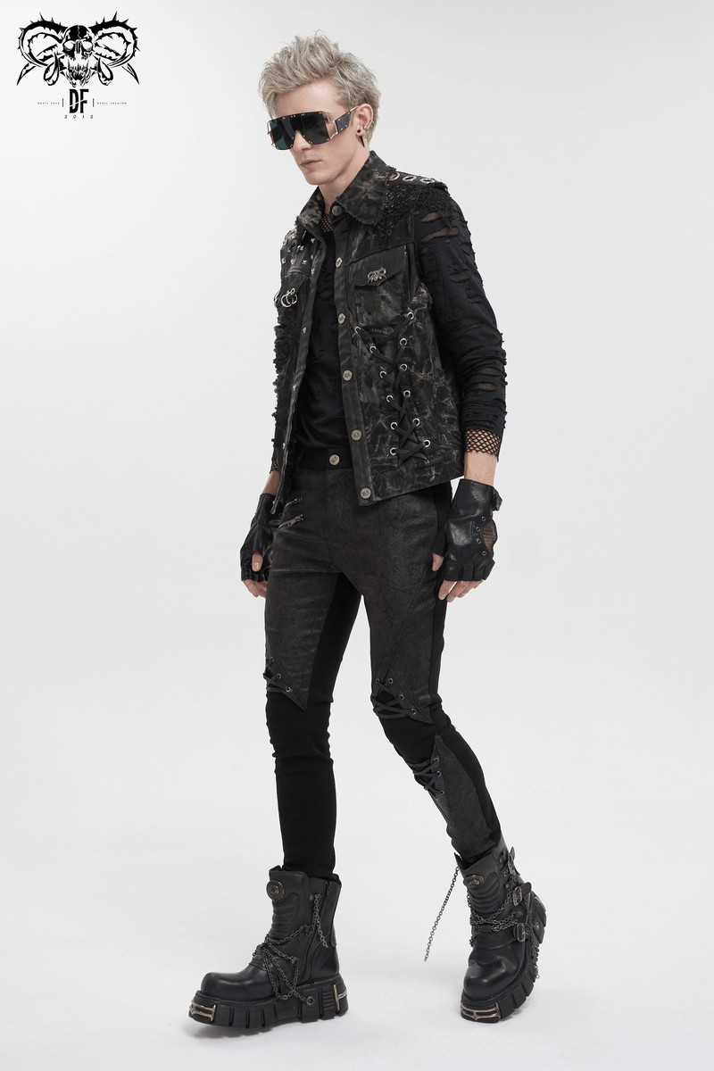 Punk rock model in asymmetrical distressed waistcoat, gothic style, mesh rivets, striking an edgy pose with black boots.