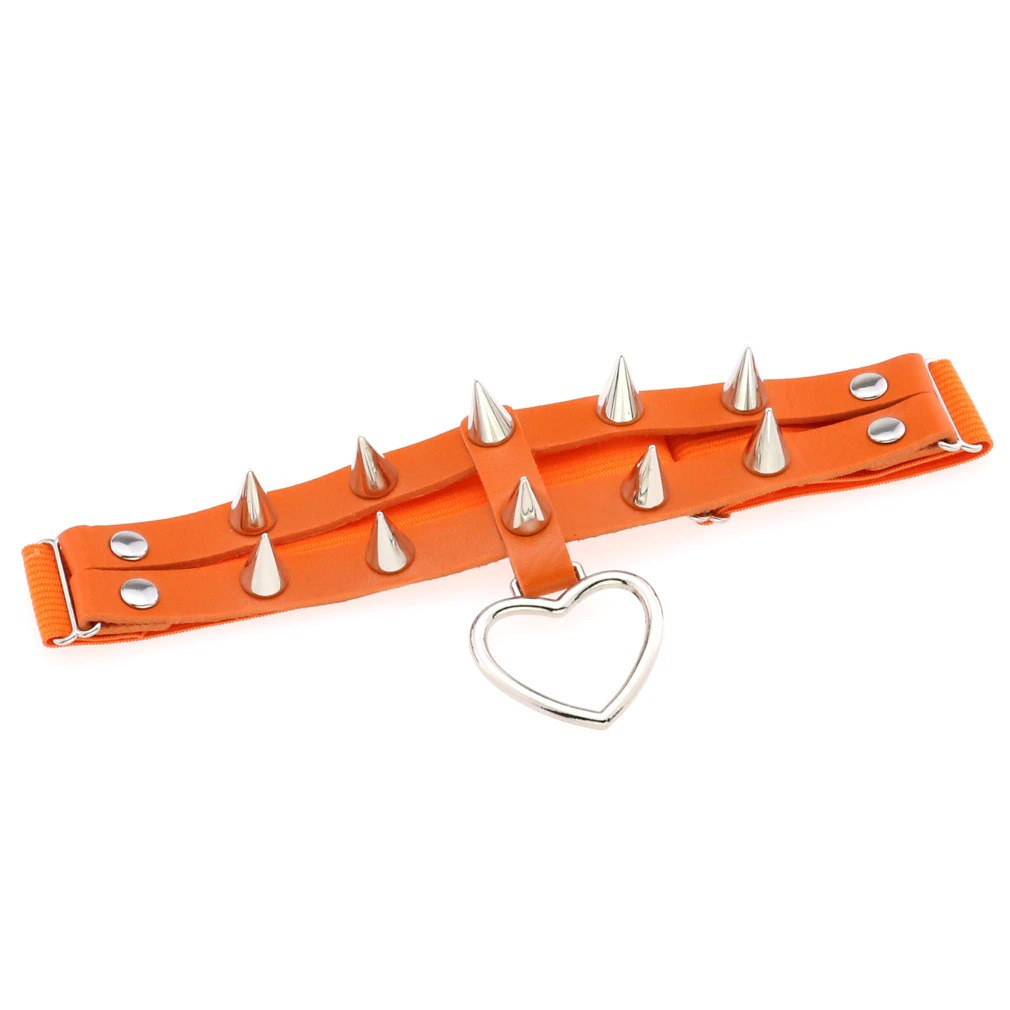Punk rock women's leg garter belt in orange with silver spikes and heart pendant for edgy fashion style.