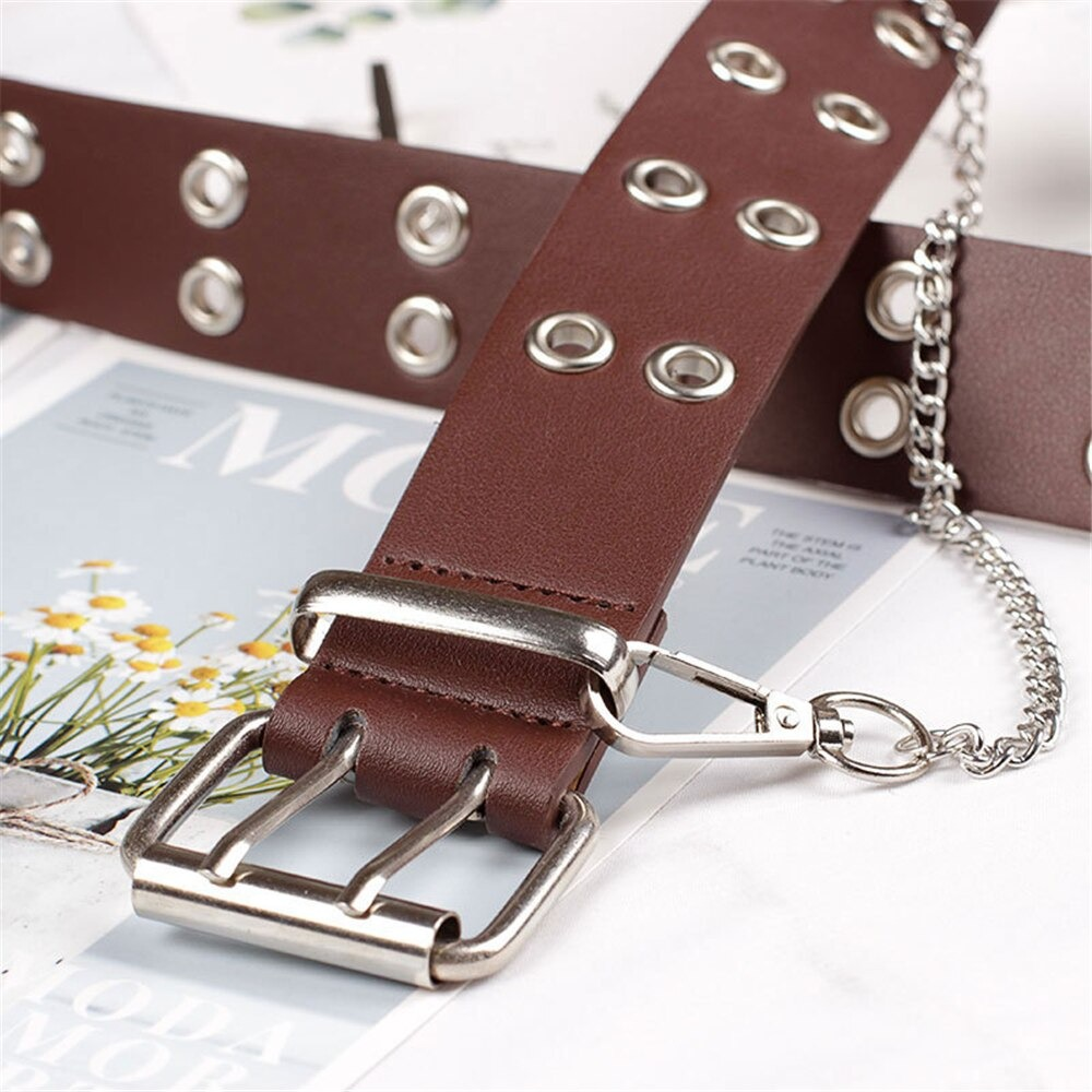 Punk rock women's PU leather belt with pin buckle and chain detail, stylish design on a magazine backdrop.