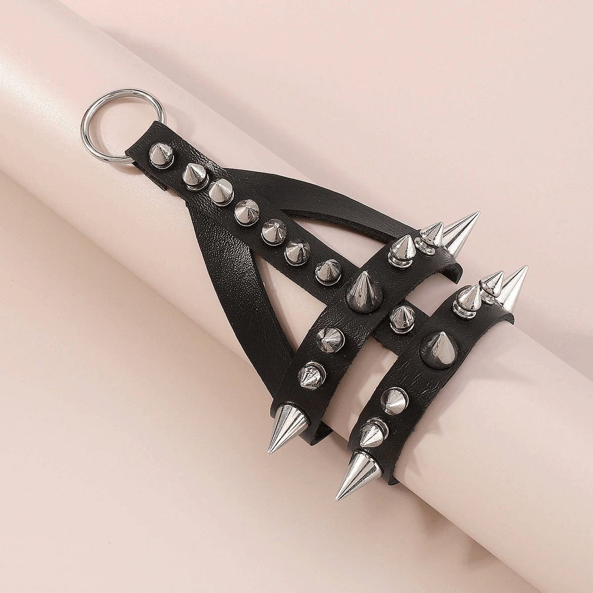 Punk rock style leather bracelet with spikes, perfect accessory for a bold women's outfit.