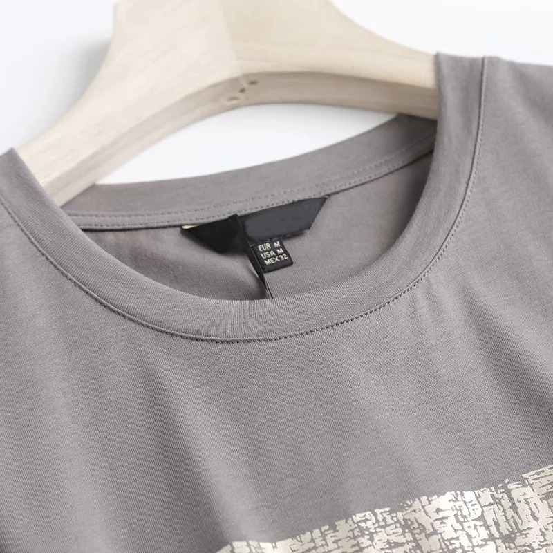 Close-up of a grey O neck cotton T-shirt showcasing its soft fabric and stylish neckline for casual punk rock outfits.