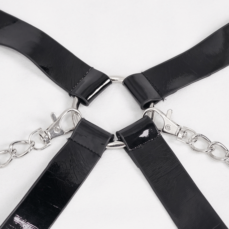 Close-up of a punk sexy black body harness lingerie set featuring metal chains and clips.