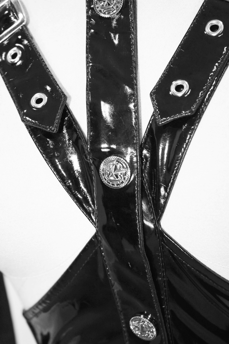 Close-up of a black shiny harness with silver accents and eyelets, showcasing a punk-style fashion detail.