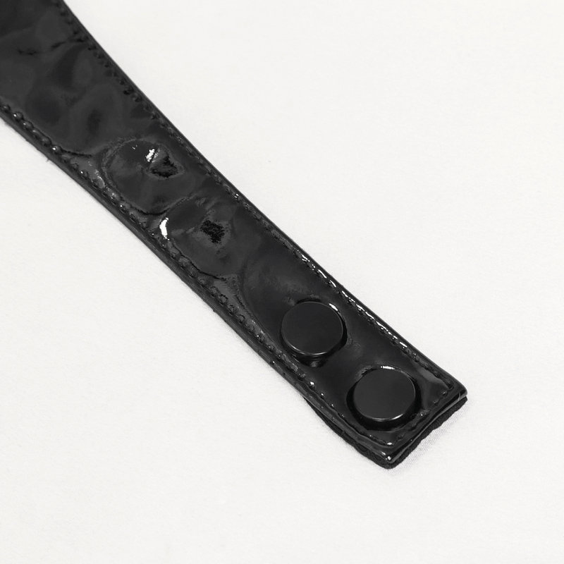 Close-up of black PU leather strap with snap closure, perfect for punk-style fashion accessories.