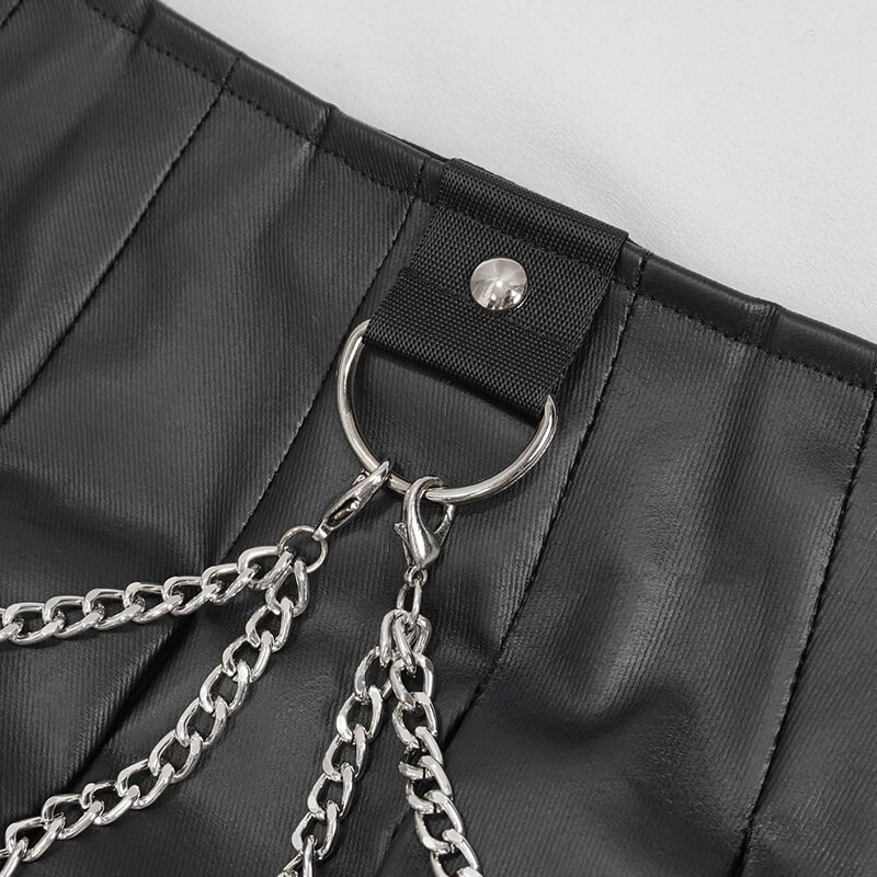 Close-up of punk short pleated skirt detail showcasing silver chains and snap closure.