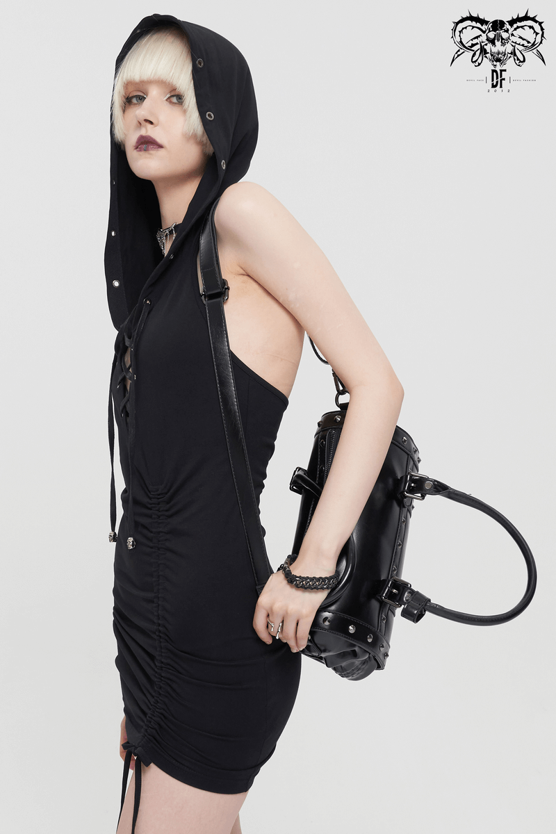 Model in black dress with hood, showcasing a stylish punk skull rivets leather handbag.