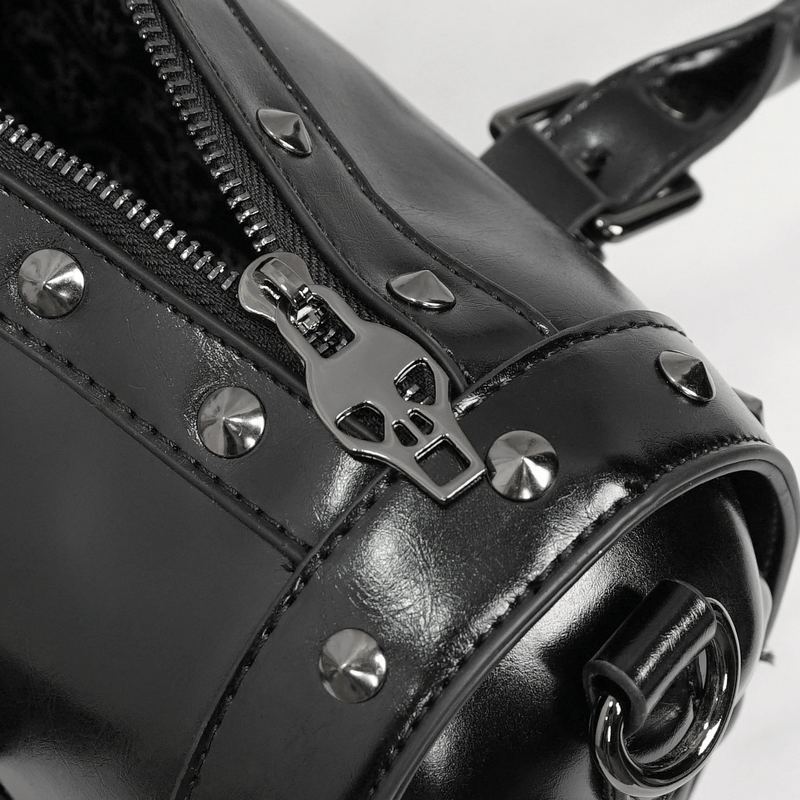 Close-up of punk black handbag showcasing skull zipper and rivets for a stylish rocker accessory.