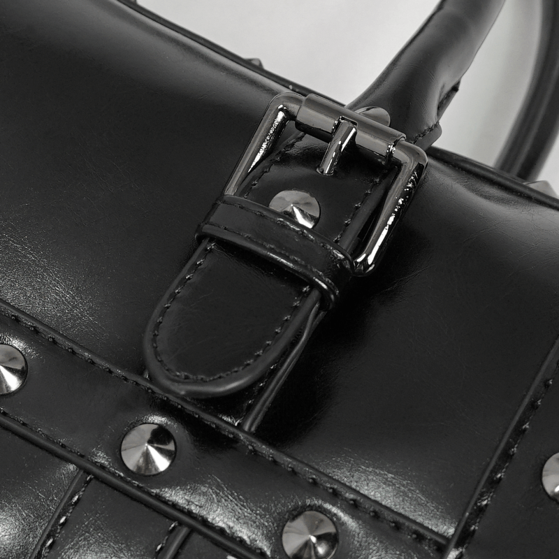 Close-up of punk-style black PU leather handbag with rivets and buckle detail.