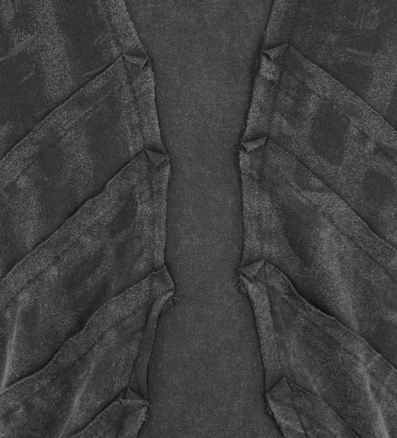 Close-up of black punk sleeveless top fabric featuring spikes and textured details for men.