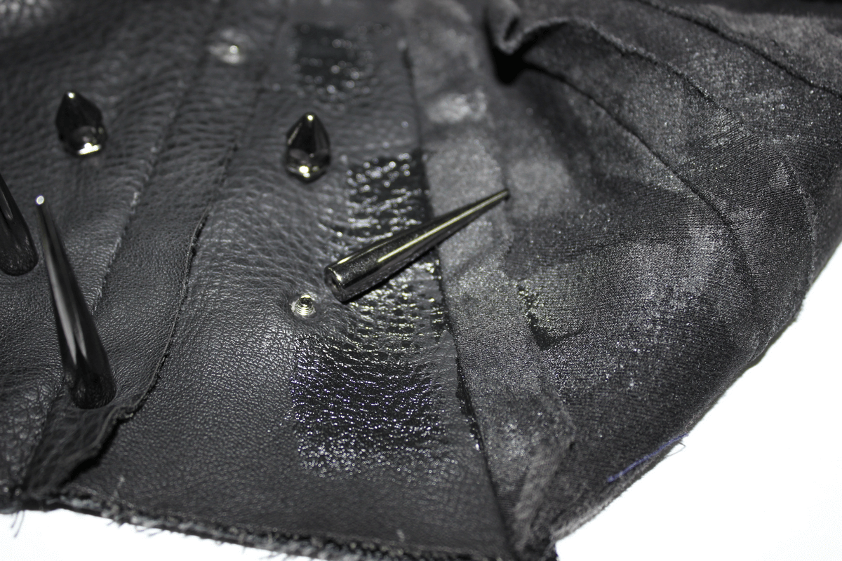 Close-up of black punk top showing spikes and detailing, perfect for an edgy alternative fashion style.