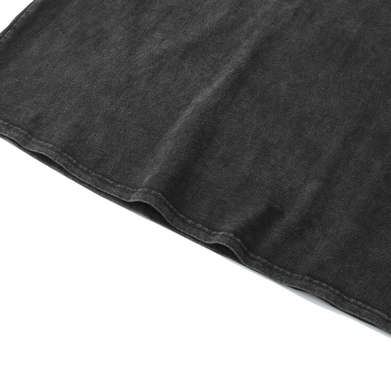 Close-up of a casual, distressed punk style tank top in dark gray fabric, showcasing its modern cut and unique texture.