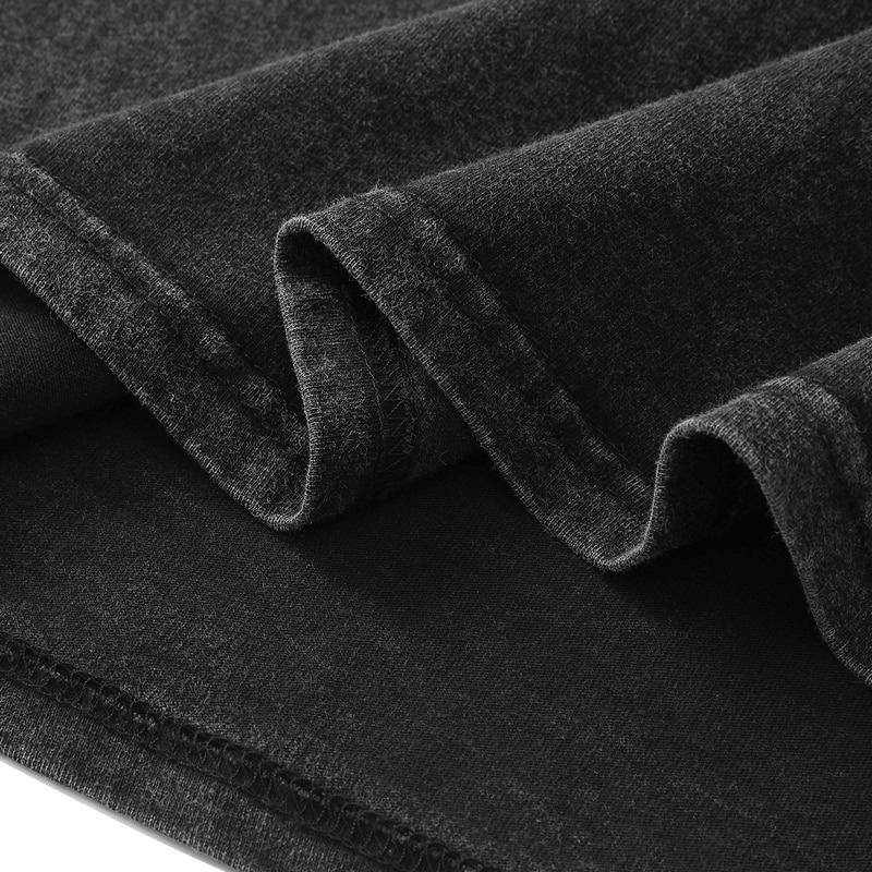 Close-up of soft, dark fabric folds showcasing the texture for a punk style anime graphic tank top.