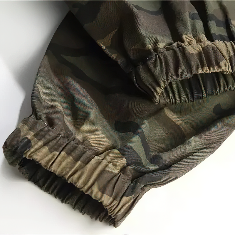 Close-up of camouflage patterned cargo pants with elastic cuffs, showcasing punk style and comfort.