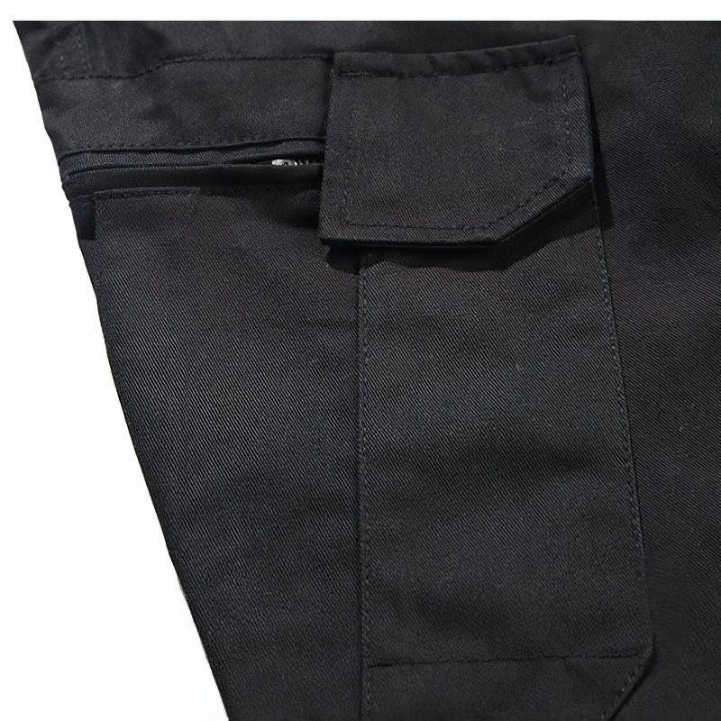 Close-up of black punk style cargo pants showing zipper pocket and durable fabric.