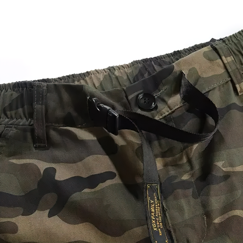 Close-up of punk style cargo pants in camouflage with elastic waistband and button detail.